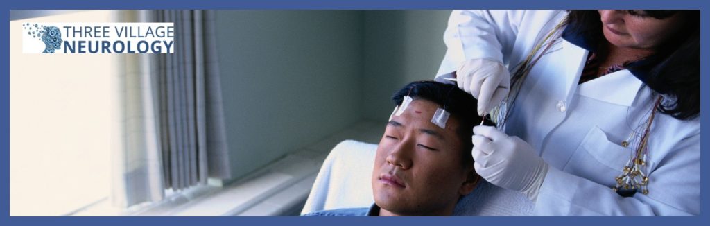 A person is undergoing a neurological test with electrodes on their head while a private epilepsy specialist monitors the procedure.